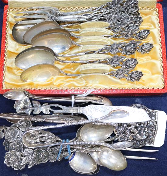 A small quantity of assorted Continental white metal flatware and a pair of English silver sugar tongs.